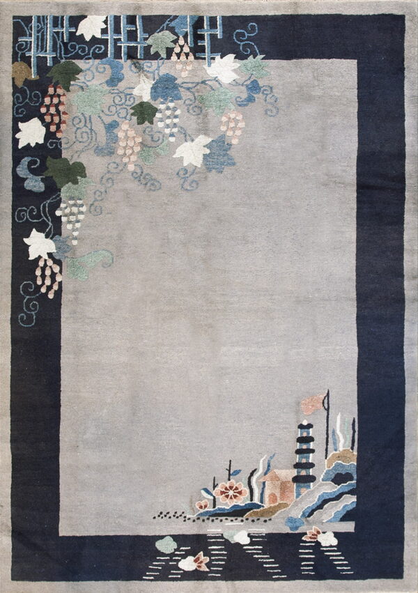 A gray rug with a wide dark blue border, featuring detailed colorful grape vines and a pagoda landscape scene.