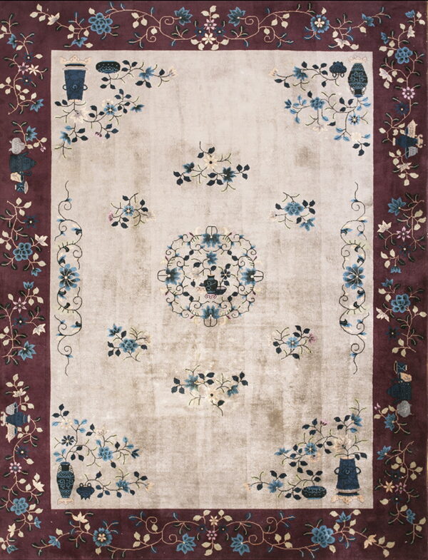 Beige and burgundy traditional rug featuring a blue floral pattern, central motif, and decorative vases.