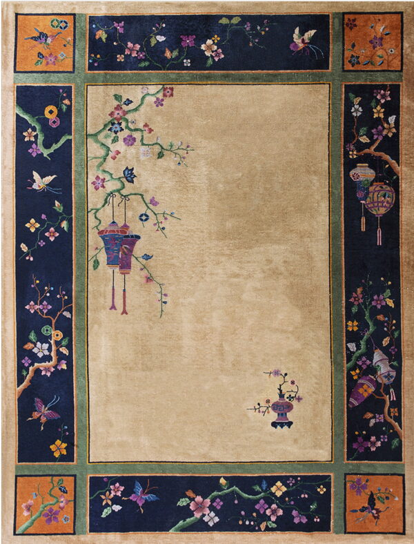 High-pile beige rug with a contrasting navy border decorated with intricate flowering vines and hanging lanterns.