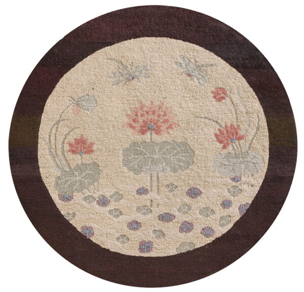 Circular rug with a dark brown border and beige center, patterned with pink and green floral elements.