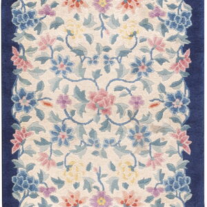 Oval runner rug featuring a symmetrical blue, pink, and yellow floral design bordered by solid navy blue.