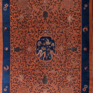 Rust and navy rug with a dense scrolling vine pattern, symbolic motifs, and a detailed central panel.
