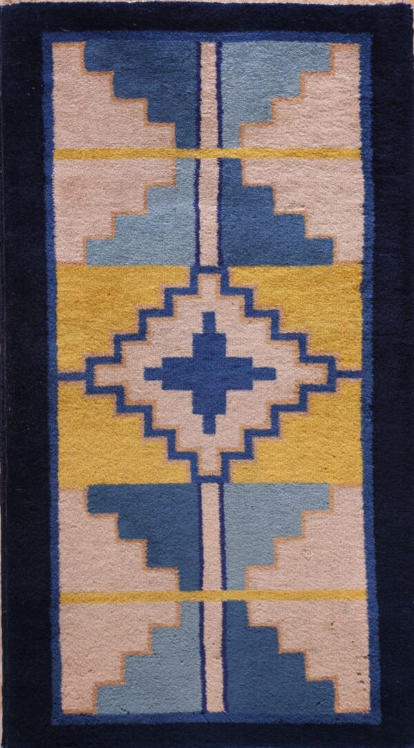 Geometric rug with dark blue borders and stepped designs in gold, light blue, medium blue, and pale pink.