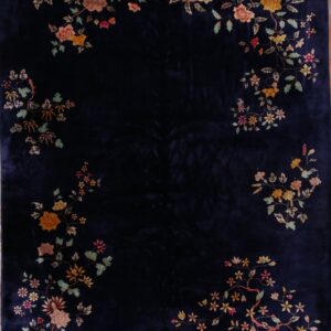 Velvety navy rug with colorful vine and floral patterns surrounding the dark center field.