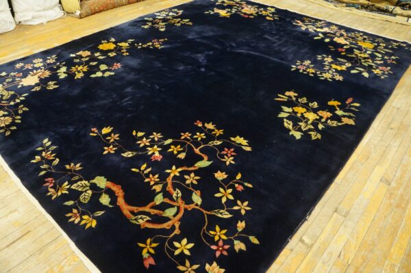 Deep blue high-pile rug featuring scattered golden floral and branch designs on distressed wood planks.