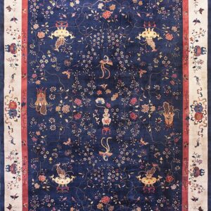 Detailed navy rug with multicolor flowering vines, birds, and vases, framed by an ivory border.