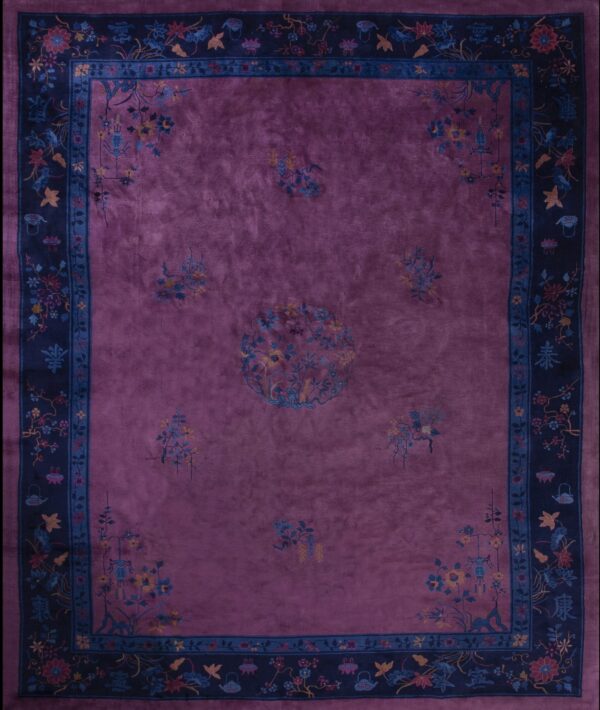 Deep magenta rug with a dark blue border featuring scattered floral and traditional chinese motifs.