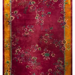 Deep magenta rug with multicolored floral vines and a wide golden orange outer border.