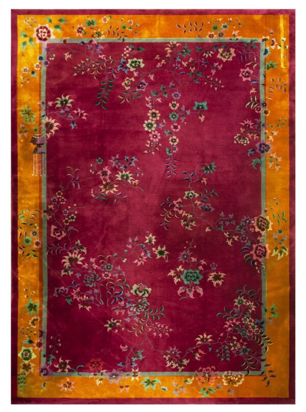 Deep magenta rug with multicolored floral vines and a wide golden orange outer border.