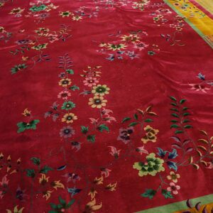 Velvety magenta rug with detailed multicolored floral sprays and a contrasting yellow and green border.