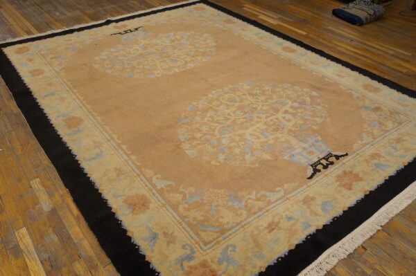 Beige rug featuring two large floral vase medallions, light blue accents, and a wide black outer border.
