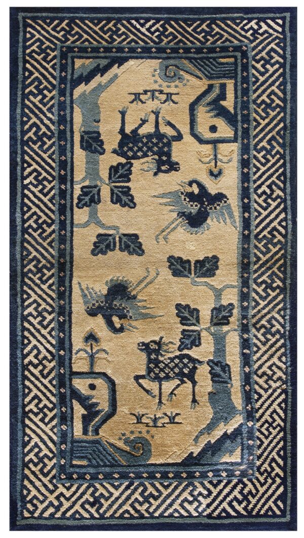 Tan rug with navy and muted blue stylized animals and foliage, framed by a wide fretwork border.