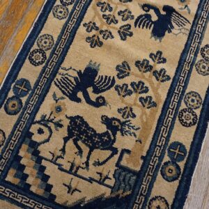Low-pile beige and navy runner displaying stylized birds and animals on weathered wood planks.