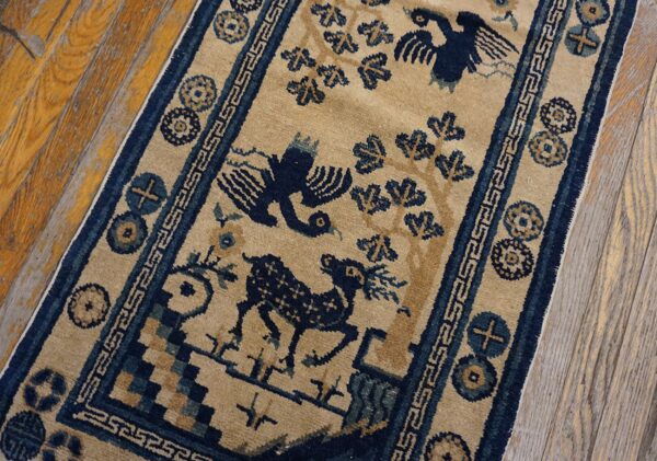 Low-pile beige and navy runner displaying stylized birds and animals on weathered wood planks.