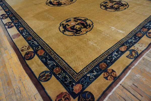 Gold rug with blue dragon medallions and a wide, ornate blue and gold border on wood flooring.