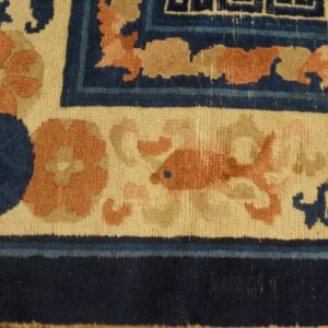 High-pile rug corner detail shows navy, cream, and peach colors in floral, fish, and geometric patterns.