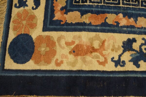 High-pile rug corner detail shows navy, cream, and peach colors in floral, fish, and geometric patterns.