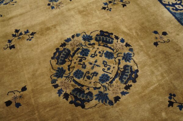 Gold high-pile rug featuring a round medallion design with intricate blue and tan floral motifs.