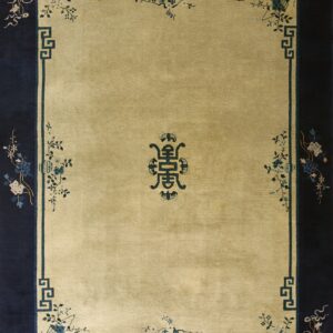 Rectangular rug with a gold field, navy border, and stylized blue geometric and floral patterns.