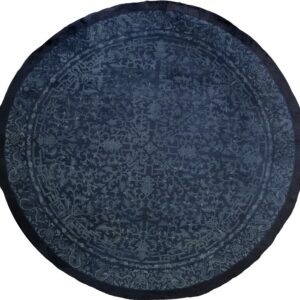 Circular navy blue rug with intricate light blue traditional motifs and a subtle darker border.