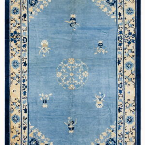 Light blue rug with cream and dark blue borders and a central floral medallion pattern.
