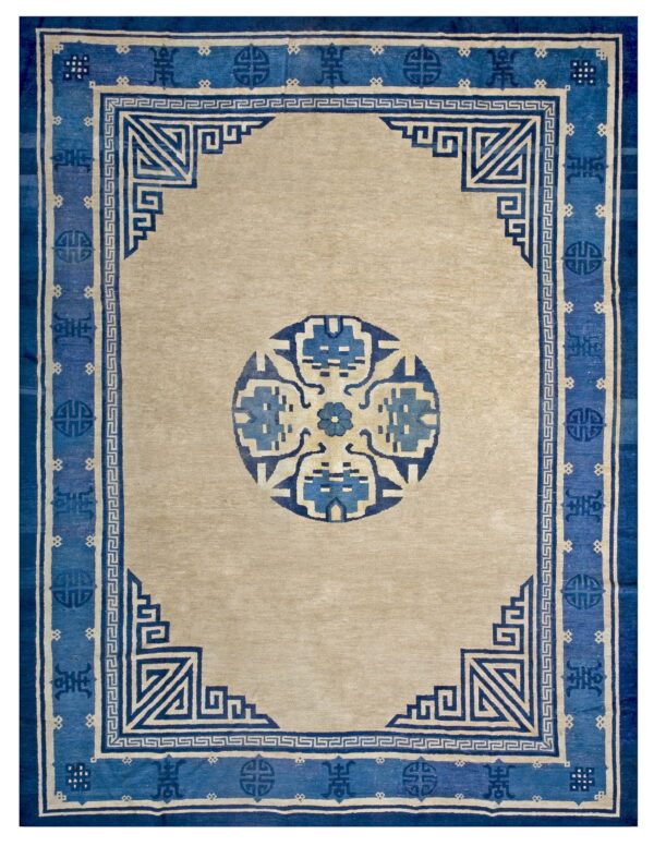 Antique chinese - peking chinese knotted rug 1 Beige rug with a bold blue border featuring geometric fretwork and a stylized central medallion.