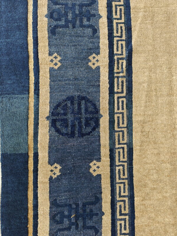 Antique chinese - peking chinese knotted rug 4 Blue and tan rug borders feature vertical stripes, geometric medallions, and a repeating meander or fretwork pattern.