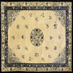 Cream and dark blue rug featuring a circular center medallion, scattered sprigs, and multi-layered patterned borders.