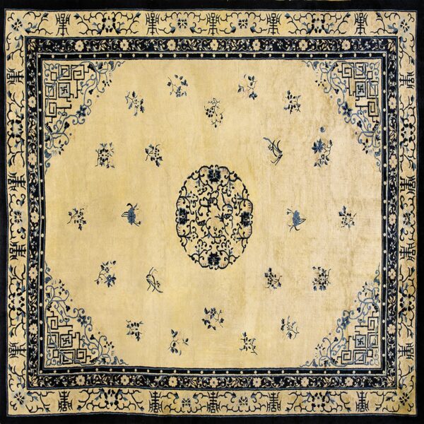 Cream and dark blue rug featuring a circular center medallion, scattered sprigs, and multi-layered patterned borders.