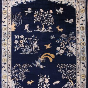 Deep blue rug with a detailed scenic pattern of cream birds, trees, goats, and a character-filled border.
