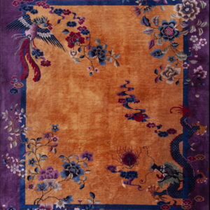 Orange field rug with a deep purple border featuring detailed blue dragon and phoenix motifs.