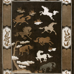 Plush dark brown rug patterned with running horses, surrounded by a wide border with stylized weapons and instruments.