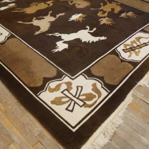 Dark brown rug with stylized tan and cream animals and geometric border on worn wooden flooring.