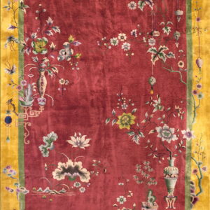 High-pile red rug with elaborate floral patterns, framed by a green line and a broad golden yellow border.