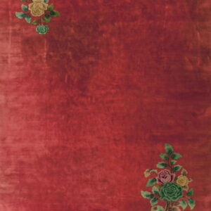 Red rug with low pile featuring floral clusters of yellow, green, and pink in diagonal corners.