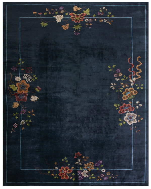 Navy blue rug with a light blue line border and multicolored, intricate floral patterns on the perimeter.