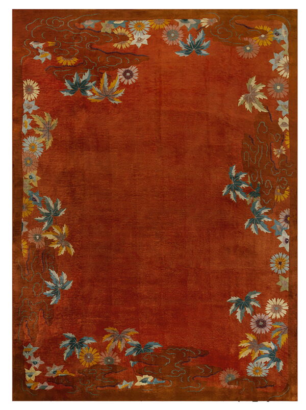 Terracotta rug with an ornamental border of multicolored flowers, leaves, and stylized swirling motifs.