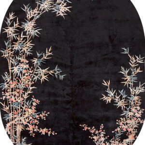 Oval black rug patterned with tan, blue, and pink oriental bamboo and flowering branches.