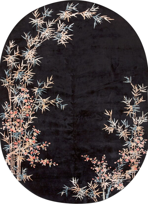Oval black rug patterned with tan, blue, and pink oriental bamboo and flowering branches.