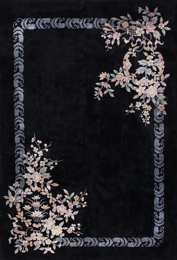 Black rug with a gray scroll border and delicate pastel floral clusters in two opposite corners.