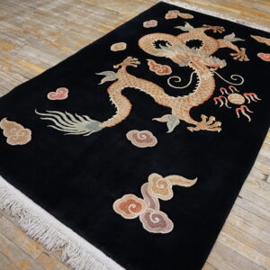 Plush black rug with a central beige dragon and colorful cloud motifs displayed on distressed wood floors.