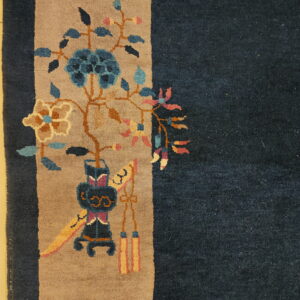 Dark blue rug detail shows a tan border with stylized blue and pink floral designs on a glossy cream floor.
