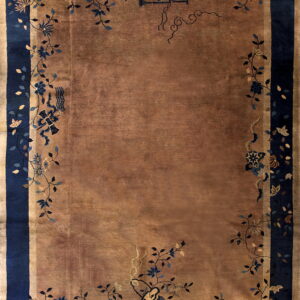 Traditional style rug featuring a solid copper-toned field and wide navy blue border with floral vines.