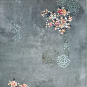 Low-pile slate rug featuring scattered pink and teal floral sprays and subtle traditional motifs.