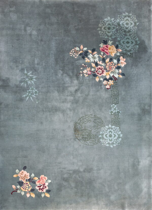Low-pile slate rug featuring scattered pink and teal floral sprays and subtle traditional motifs.