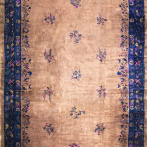 A lustrous gold rug with scattered floral bouquets and wide, ornate indigo blue borders.