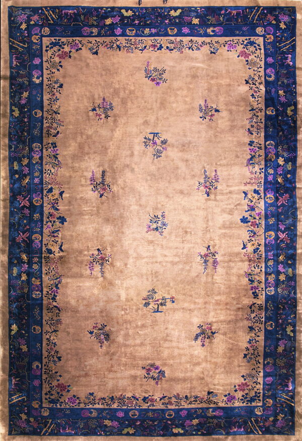 A lustrous gold rug with scattered floral bouquets and wide, ornate indigo blue borders.