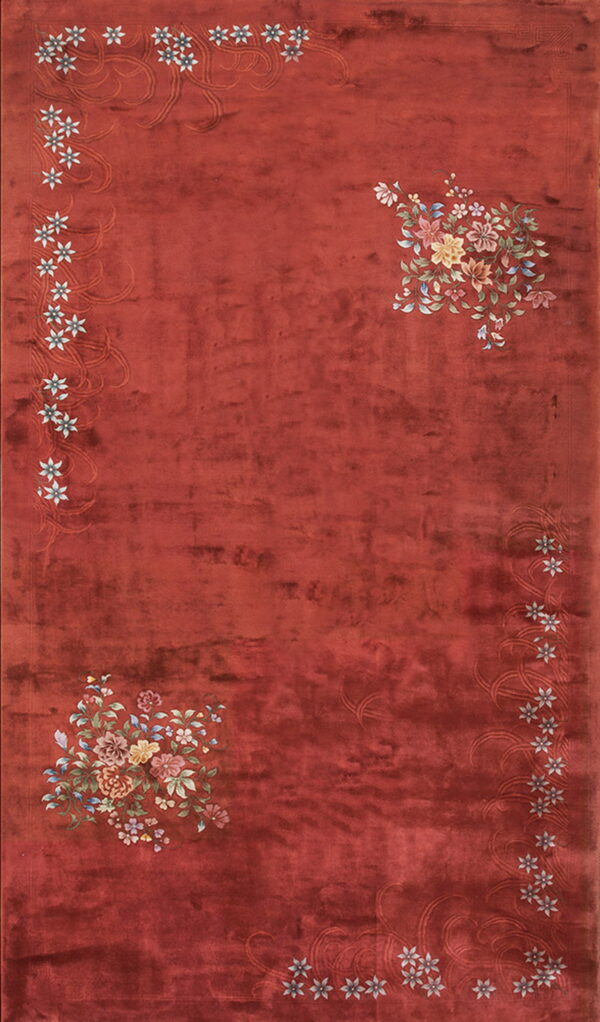 Rust-toned plush rug with colorful floral bouquets in two corners and a border of small white flowers.