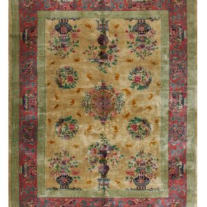 A golden beige rug featuring detailed floral vases and medallions, framed by red and sage borders.