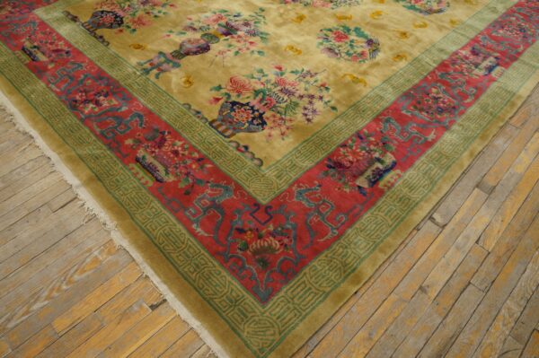 High-pile yellow rug displaying vibrant floral vases and a thick red and teal patterned border on rustic wood floors.